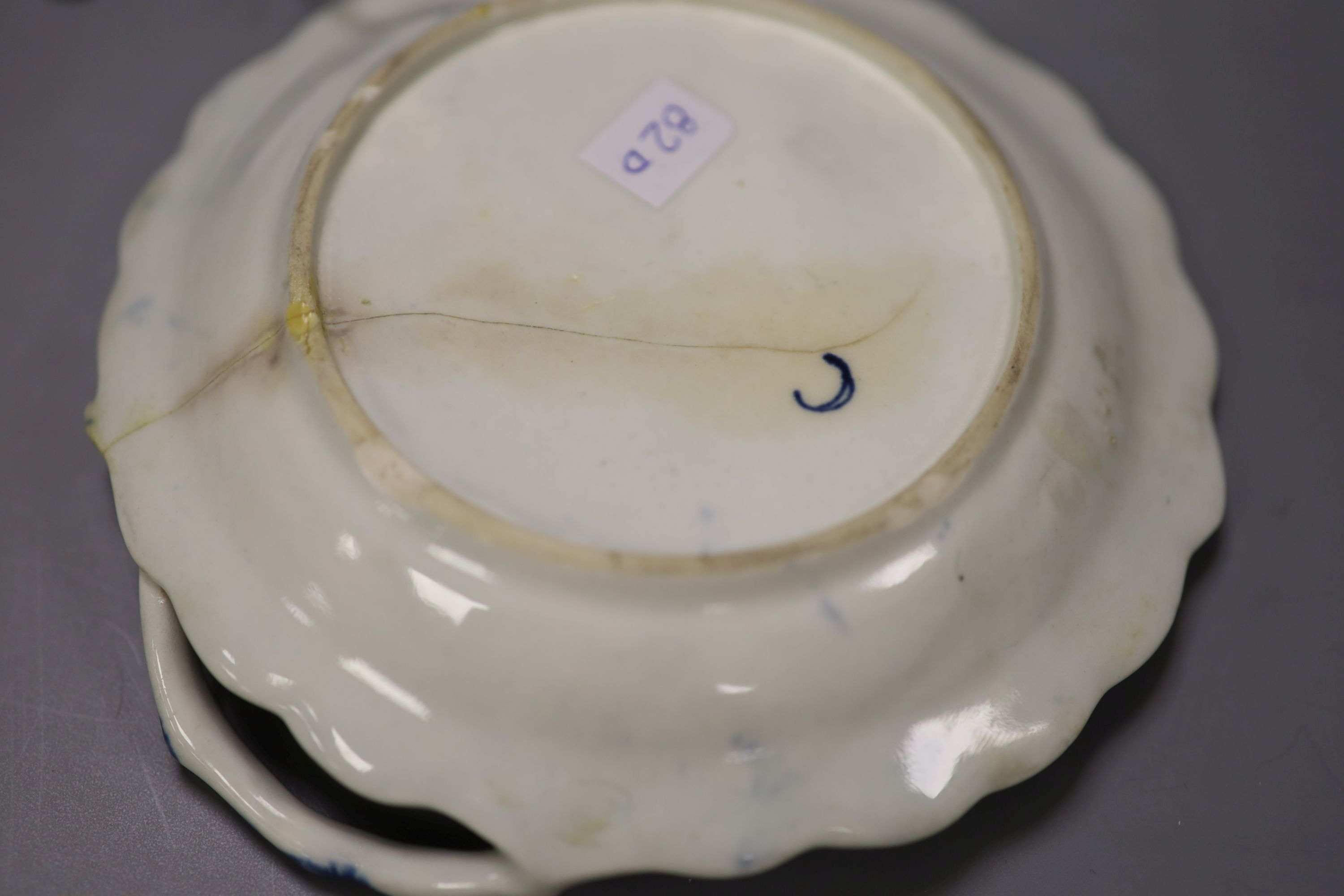 A Worcester small sauceboat painted with Two Porter Landscape in moulded panel, flowers verso, c.1760
